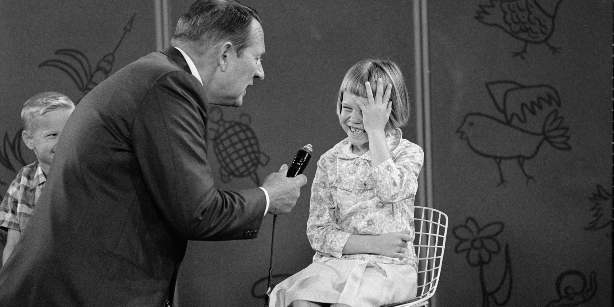 Canadian-born television host Art Linkletter (born Arthur Gordon Kelly) holds the microphone as he interviews an unidentified, laughing girl on an episode of the 'Kids Say the Darndest Things' segment of 'Art Linkletter's House Party,' April 23, 1965. (Photo by CBS Photo Archive/Getty Images)